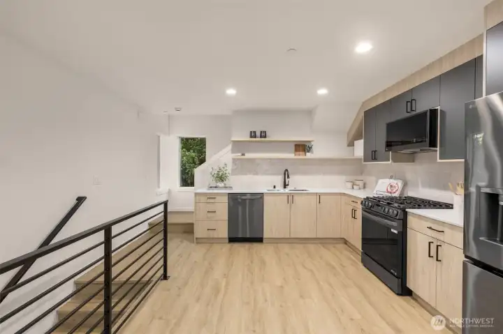Gourmet kitchen equipped with premium stainless appliances, custom cabinetry, and a designer tile backsplash.