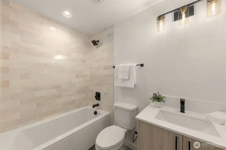 Spacious primary bedroom featuring large windows and ample room for a king-sized bed.