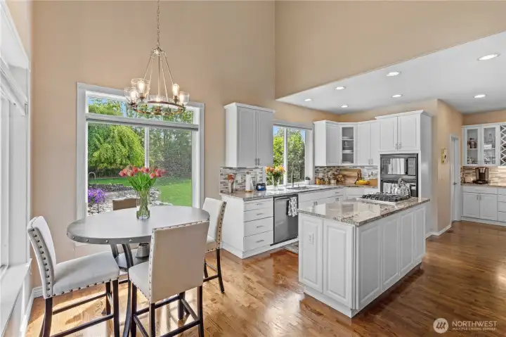 Light filled kitchen with eat in breakfast nook!  This overlooks your lush back yard