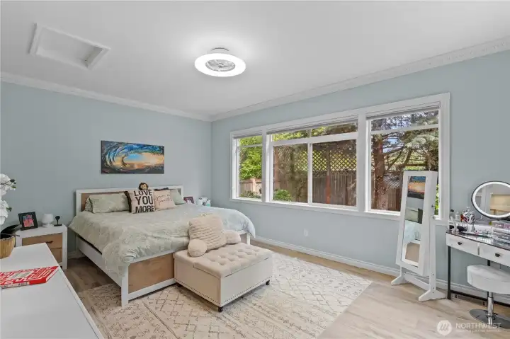 Main floor primary suite has its own view of the back yard!  Private and quiet