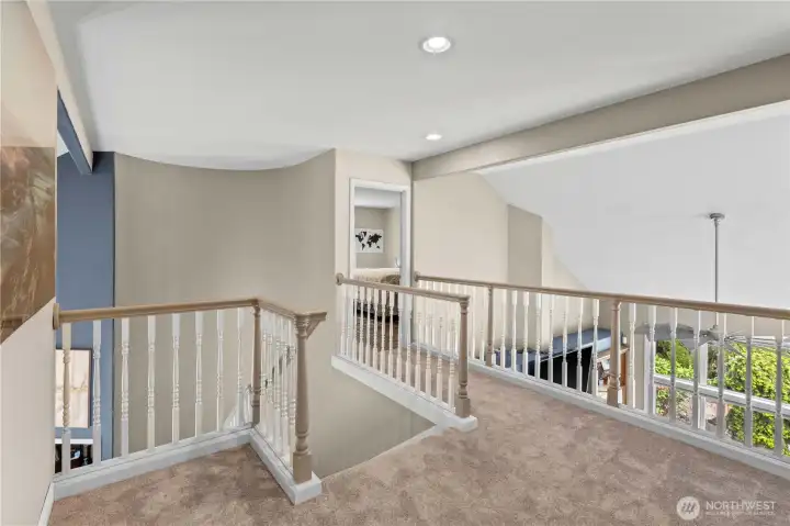 Heading upstairs we see the landing overlooking the great room