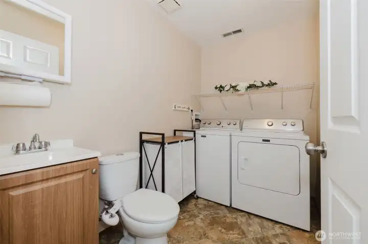 Downstairs half bath and utility room. Downstairs half bath and utility room.