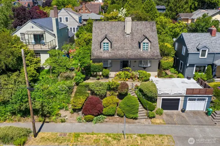 An aerial perspective, showing front gardens and patio atop the garage. An aerial perspective, showing front gardens and patio atop the garage.