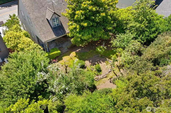 Aerial view showing the back gardens and the covered and shaded back porch - the perfect place to beat the heat. Aerial view showing the back gardens and the covered and shaded back porch - the perfect place to beat the heat.
