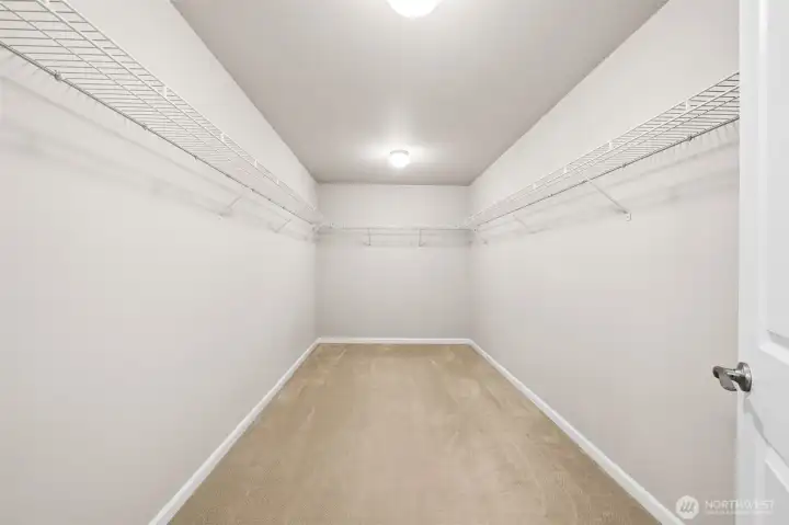 Primary bedroom walk-in closet Primary bedroom walk-in closet