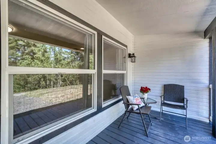 Lovely covered front porch to sit an watch the sunrise or night skies.