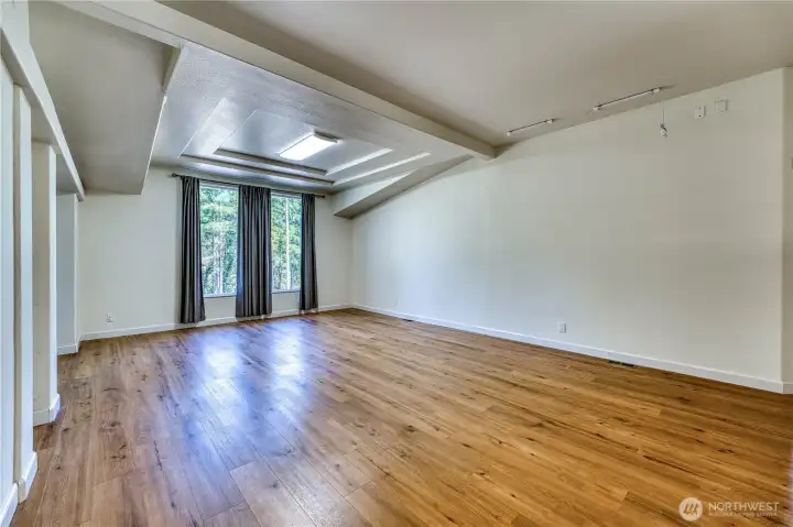 Beautiful stepped ceiling breaks up the room into separate living spaces if you like. The largest sectionals available will easily fit into this space and you will still have room for more!