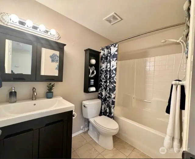 Full bath with tub/shower combo.