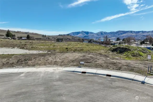 Lot 9 entrance and sidewalk. Water, sewer, irrigation, power and fiber conduit to the lot.