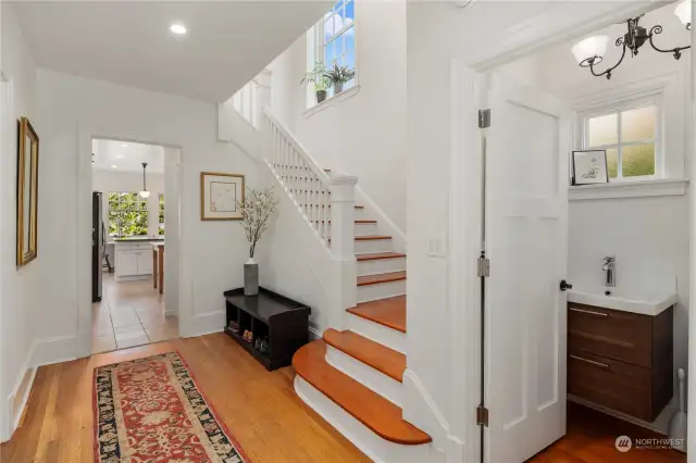 Beautiful entry and original stairs and hardwood floors