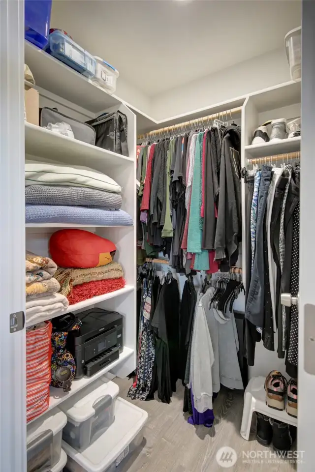 Awesome walk-in closet with built in shelving.