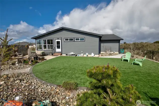 With low maintenance, beach landscaping and astro turf, this yard is both people and puppy friendly!