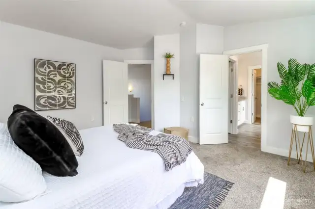 Step into the serene primary bedroom, featuring a neutral palette and large windows that overlook the peaceful backyard and the protected natural area across the street.