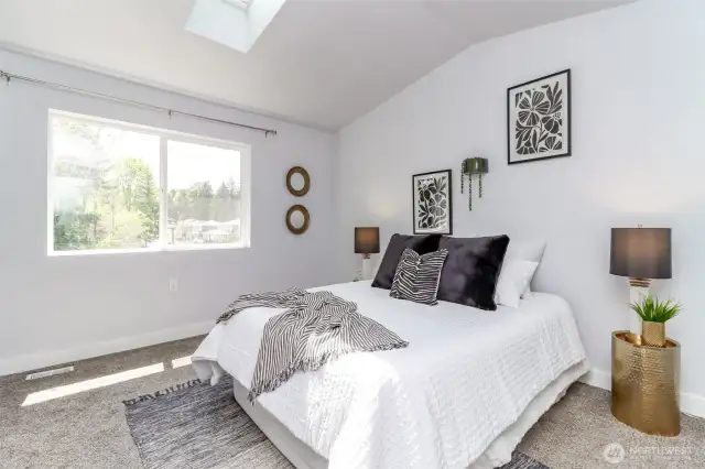 This view shows the large window and look up to the beautiful skylight added when the sellers had the roof replaced.