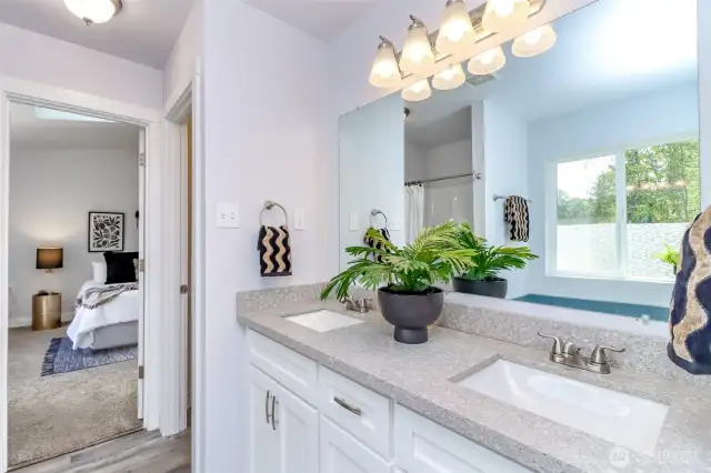 Step into the spa-like primary 5-piece bathroom featuring a double stone vanity with under-mount sinks, a spacious walk-in closet, and a private water closet for added comfort and convenience.