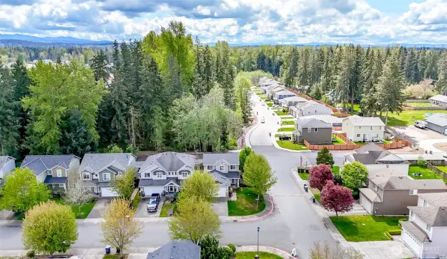 Situated on a spacious corner lot, this property is surrounded by mature trees and showcases the stunning backdrop of Northwest living at its finest.