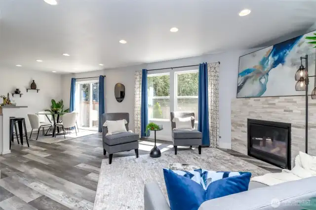 Step into the welcoming great room featuring a cozy gas fireplace framed in stone and expansive windows that flood the space with natural light. This open-concept area seamlessly flows into the dining room and kitchen, creating an ideal setting for entertaining guests and everyday living.