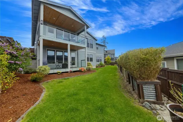 Back of house and yard. There is additional yard on the right side as well