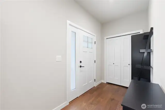 you’re welcomed by a thoughtfully designed entryway with a coat closet and built-in shoe cabinet