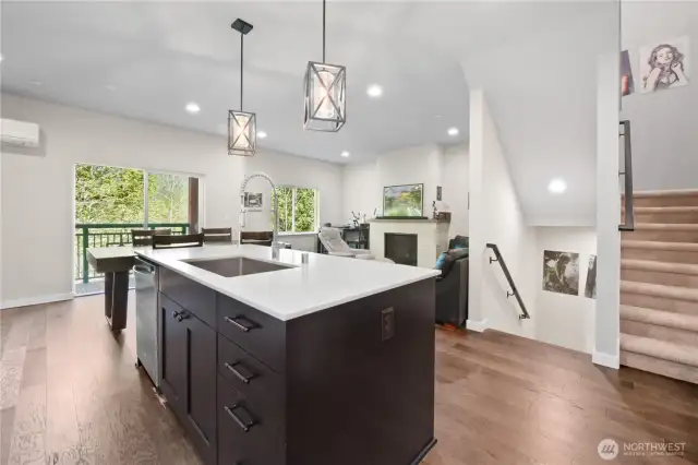 A sliding glass door leads to a private balcony overlooking a lush greenbelt, offering a sense of tranquility and connection to nature.