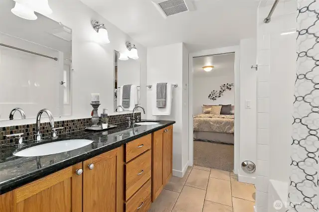 Chic shared bath with modern updates and heated tile floors.