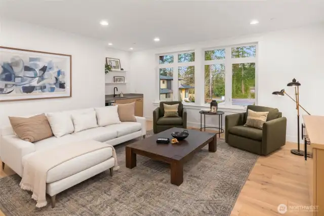 Expansive upper floor rec room features hardwood floors, wet bar with under counter beverage center, and pre wire for 5.1 Surround