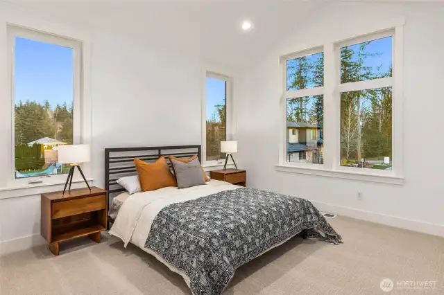 One of 5 upper floor bedrooms including primary. All bedrooms feature walk in closets  with custom built solid shelving