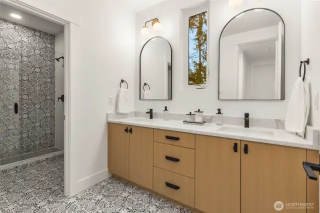 One of 3 Second Floor baths. Custom cabinets with designer slab counters, double sinks, designer tile details and frameless glass shower enclosure