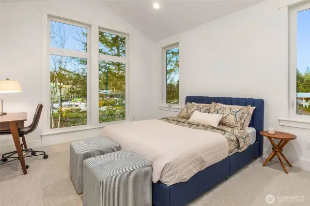 Another spacious 2nd floor bedroom flooded with light through tall windows and vaulted ceiling