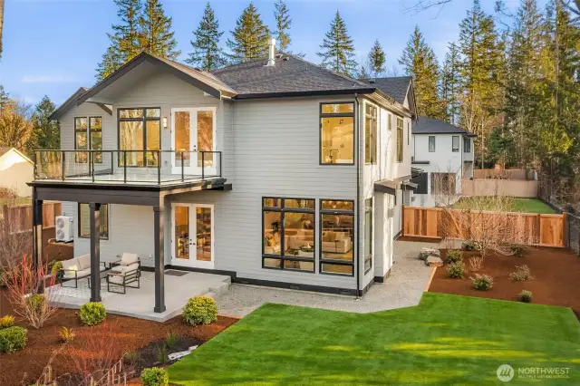 Waterproof Membrane deck with custom glass railing off 2nd floor primary bedroom creates covered patio of main floor great room. Full yard irrigation.