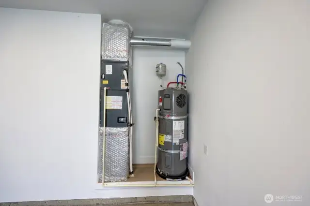 Garage area with heating unit and hot water tank