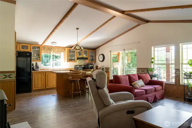 Walking into the front door. Wood stove to left. Hallway with 2bed 2bath to left.   Cozy and easy main level living!