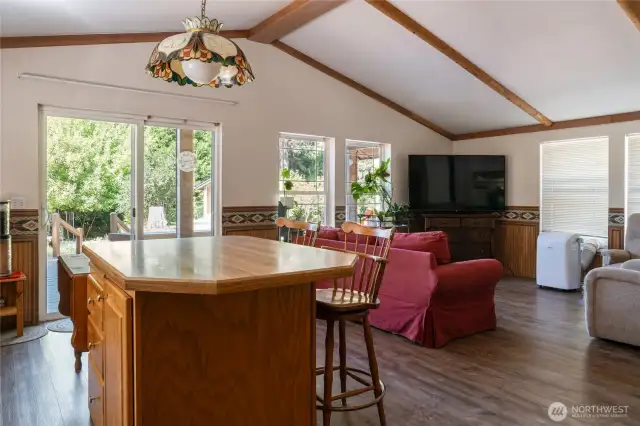 View from fridge. Laundry room and walk-in pantry behind. Wood stove and front door to right.