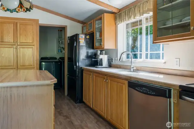 View from sliding doors. Walk-in laundry with pantry shelves straight back. Additional pantry cupboards to the left.