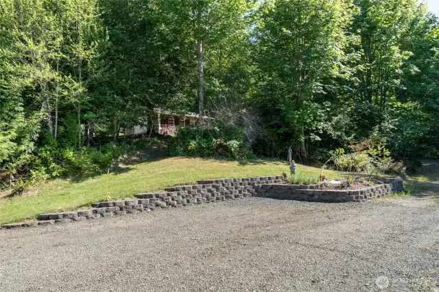 Plenty of parking! View of upper garage/shop from parking area at house.
