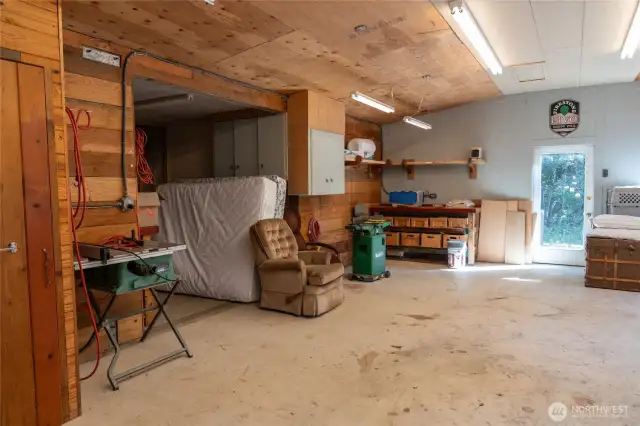 Upper garage / workshop. Bowling lane work benches. So much storage! 1/2 bath and woodstove.