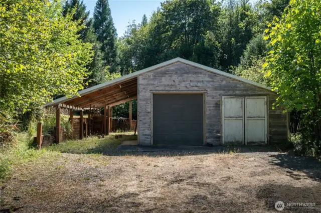 Lower "tractor barn" shop. Large carport. Automatic garage door.
