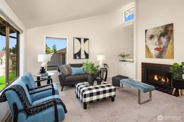 Cathedral ceilings and a cozy fireplace make this home feel welcoming and spacious.