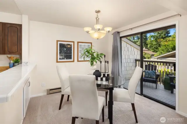 Flexible dining space looks out to a private deck.