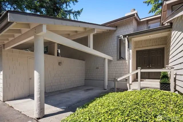Covered carport area with a storage unit.