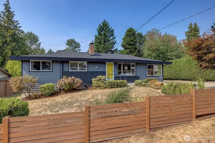Partially fenced front yard with Japanese Maples and perennials