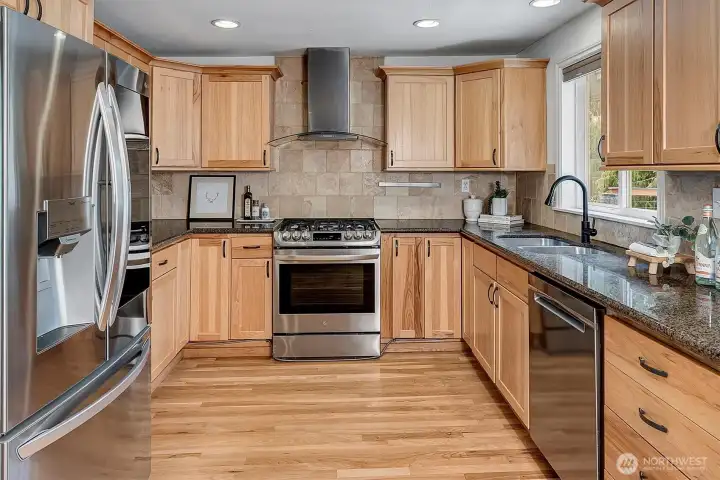 Updated kitchen with sleek cabinetry, granite counters, and stainless appliances—perfect for everyday cooking or entertaining