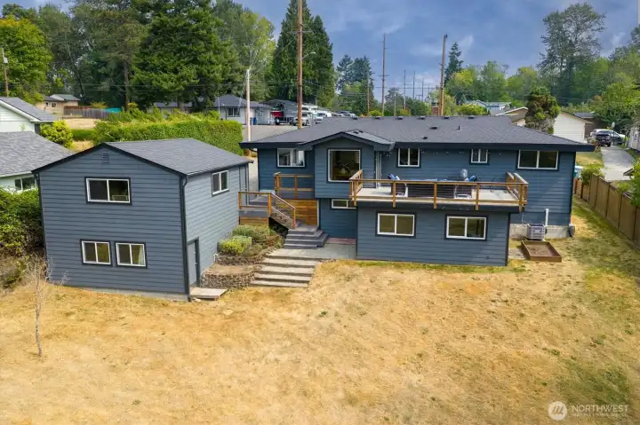 Private backyard with mature landscaping and room to relax, play, or garden in 400 square feet of raised beds