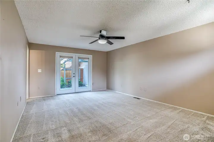 Primary bedroom w French doors to patio