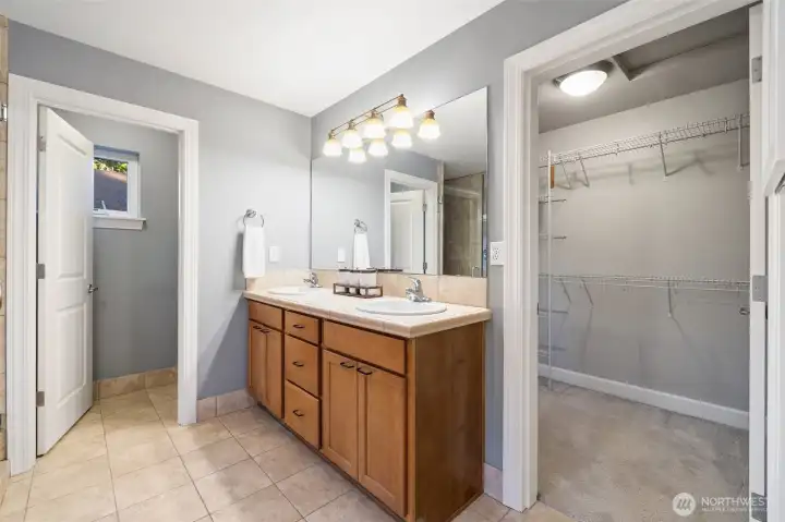 Double sink in primary bath with view into walk-in closet!
