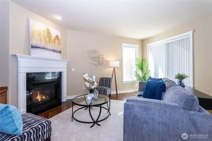 Main living area with fireplace and large windows.