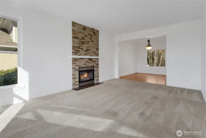 To the left of the entry, you'll find the Formal living room with partial views of Sinclair Inlet, City Lights, Ferrys, and the Olympics plus a gas fireplace for cozy nights.  Fireplace was cleaned and serviced 11/2025 and is ready for you.
