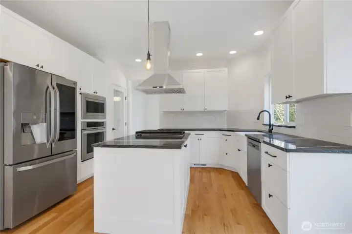 New Gourmet kitchen in 2021 with abundant Shaker cabinetry, large storage drawers, Granite Countertops, stainless appliances, cook island and pantry.  This kitchen has tons of storage and plenty of room for the cooks in your home.