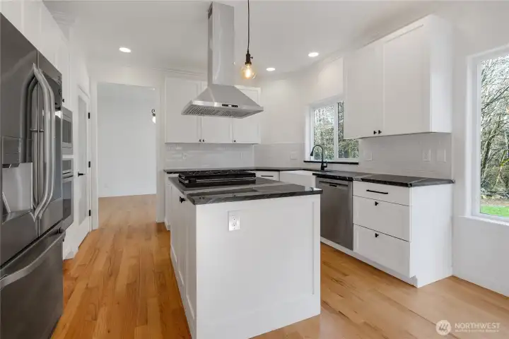 Abundant natural light floods this kitchen.  You'll enjoy beautiful territorial views from the Kitchen farm sink.  Rich hardwood floors extend from the kitchen to the formal family room.
