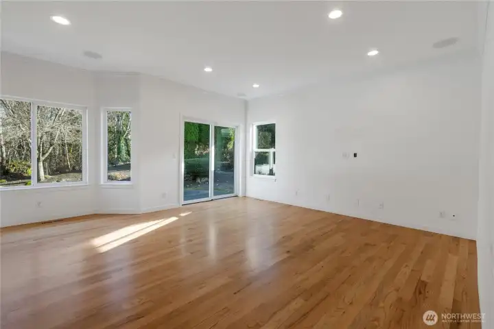 Open family room off the kitchen has richly refurbished hardwood floors, recessed lighting, and speaker system perfect for movie night!  Sliding doors lead to your private backyard with patio for BBQs.